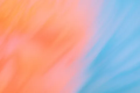 Blurred gradient with pastel orange and blue hues.